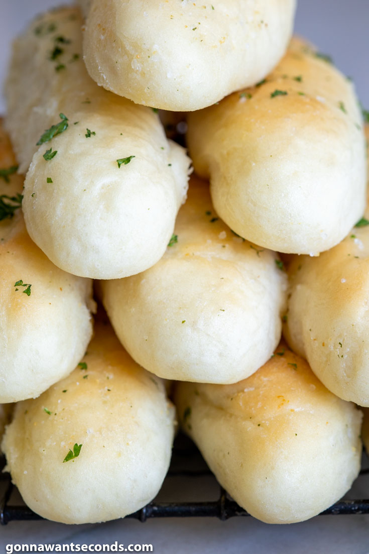 Olive Garden Breadsticks piled on top of each other, close up