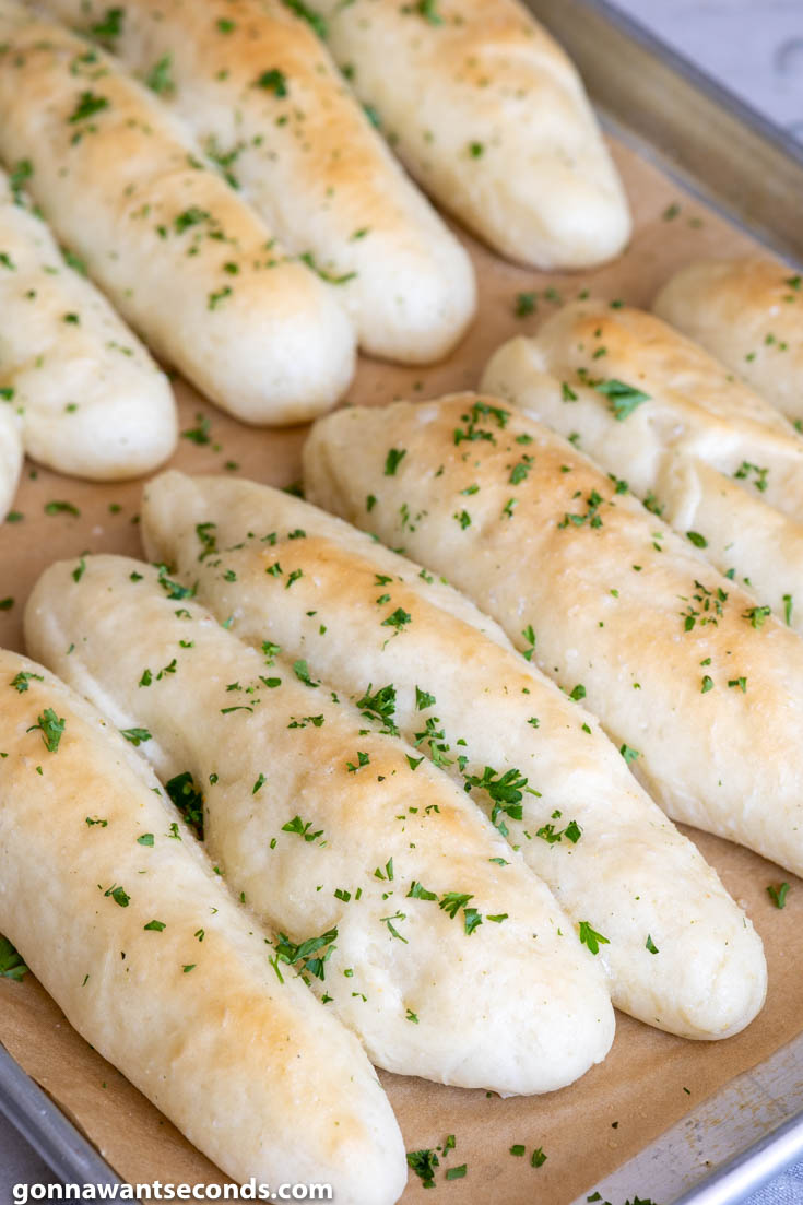 Olive Garden Breadsticks on a parchment paper, side view