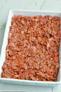 Step 6 how to make taco casserole, Spread beef mixture over beans