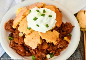 Chili cornbread casserole topped with a dollop of sour cream