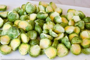 How to make Cheesy Roasted Brussels Sprouts, cutting in half