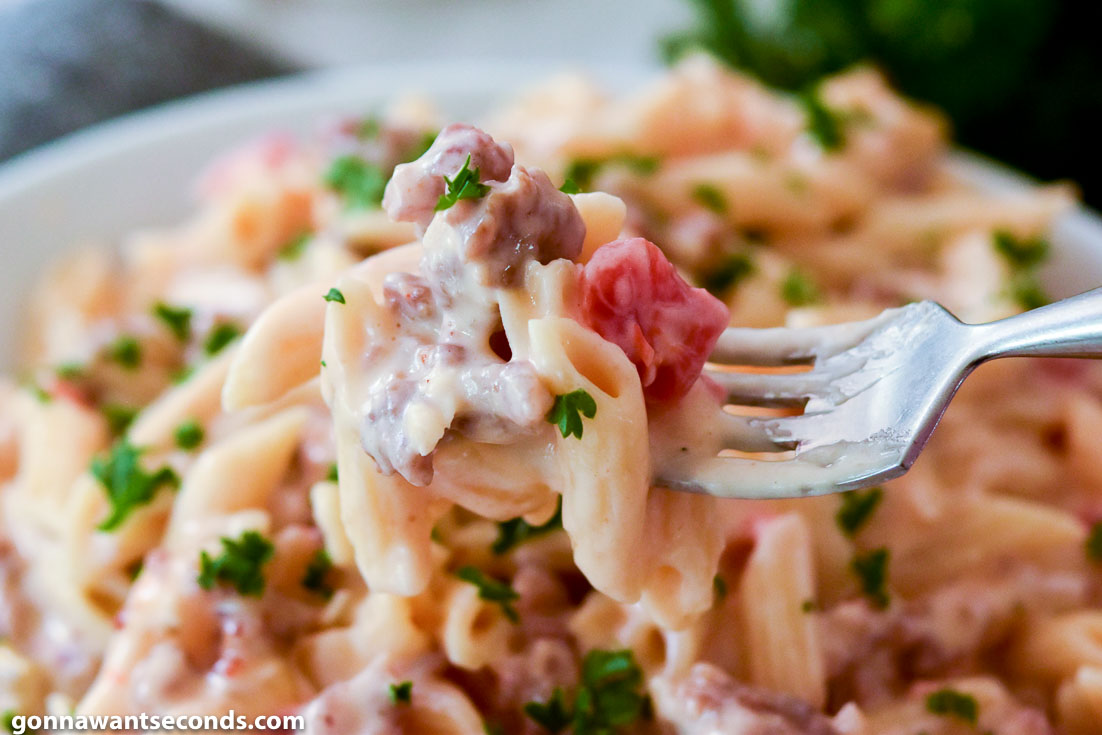 Fork scooping Creamy Rotel Sausage Pasta