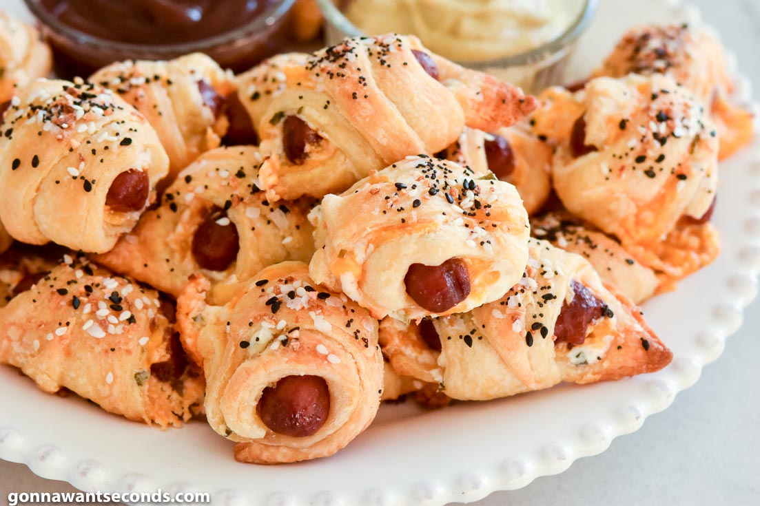 Everything Pigs in a Blanket with dipping sauce on the side on a plate