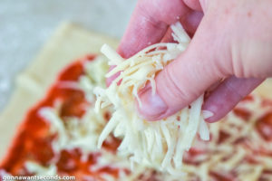 How to make Pizza Pinwheels, sprinkling shredded cheese