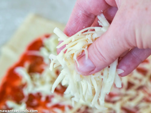 How to make Pizza Pinwheels, sprinkling shredded cheese