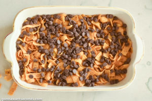 How to make Frito Bars, adding chocolate chips on top of the Fritos layer