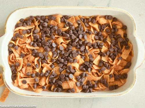 How to make Frito Bars, adding chocolate chips on top of the Fritos layer