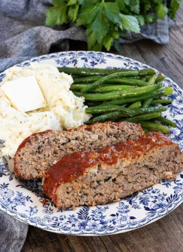 brown sugar meatloaf with mashed potatoes and green beans on a plate