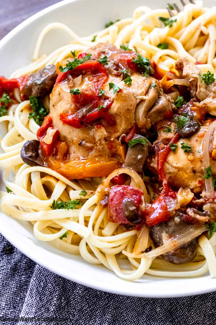 easy slow cooker chicken cacciatore on top of pasta