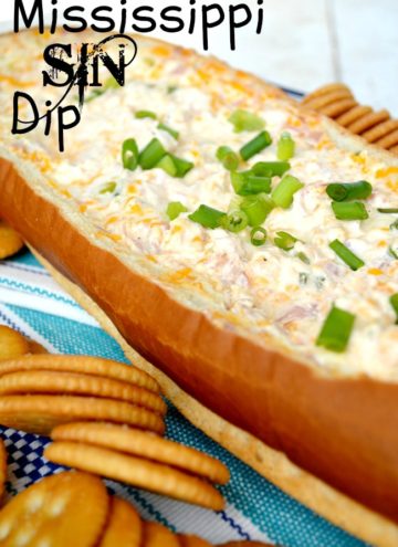 Mississippi Sin Dip in a hollowed french bread with crackers on the side