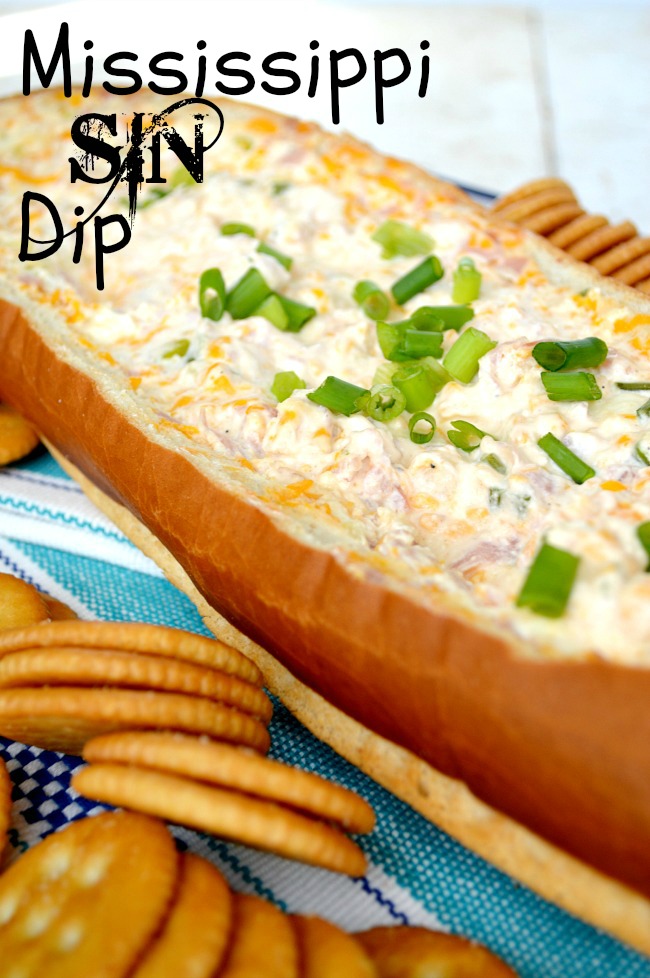 Mississippi Sin Dip in a hollowed french bread with crackers on the side 