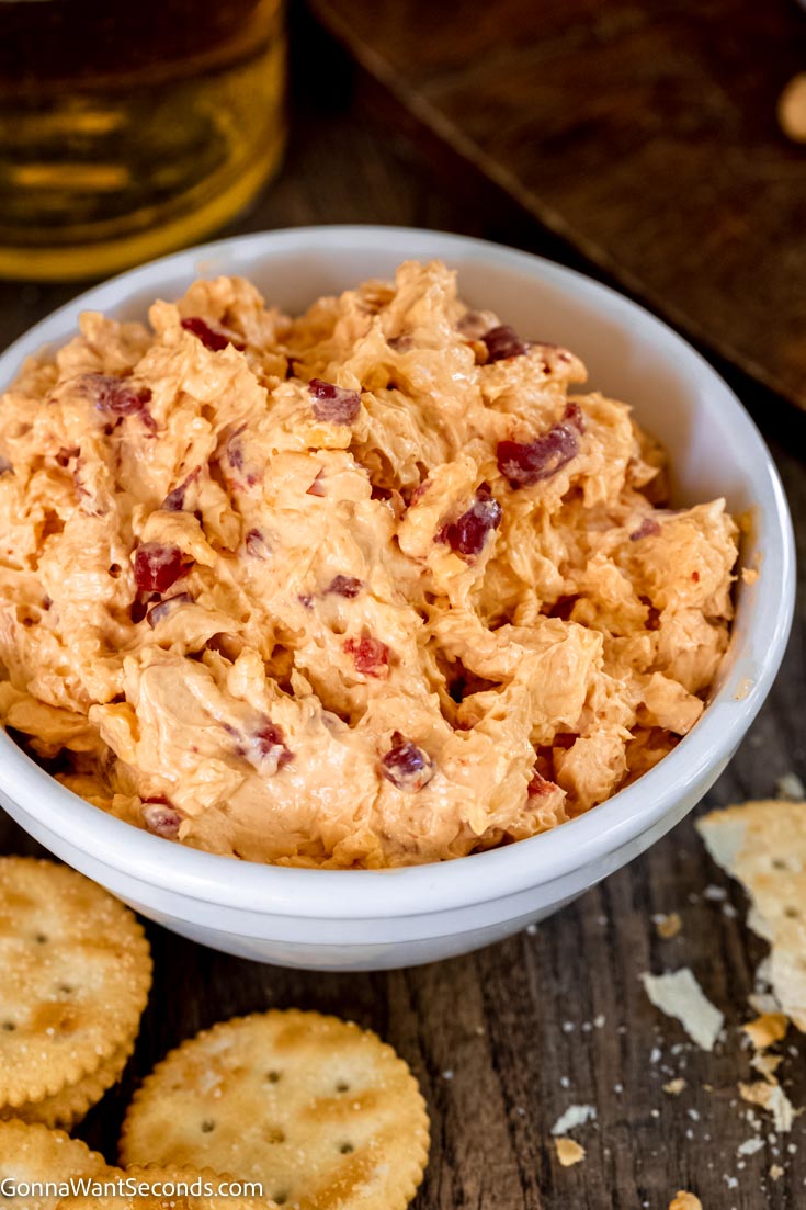 old fashioned pimento cheese recipe in a bowl with crackers on the side 