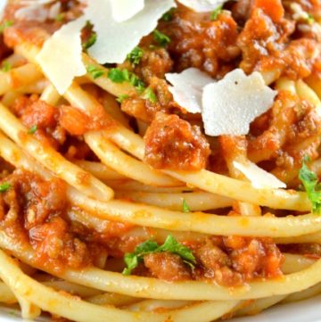 Authentic Ragu Bolognese Sauce topped with parmesan cheese on a plate