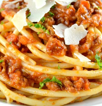 Authentic Ragu Bolognese Sauce topped with parmesan cheese on a plate