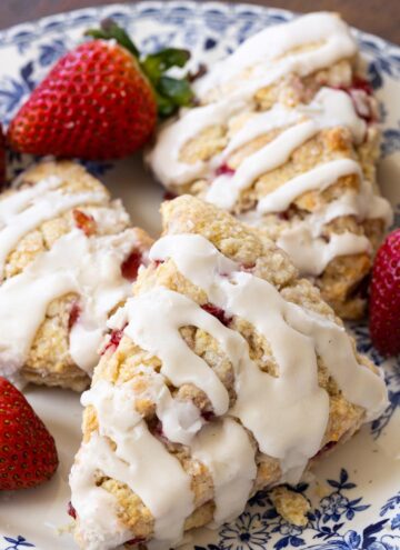 strawberry scones drizzled with glaze, on a plate