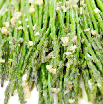 sauteed asparagus with garlic bits on top