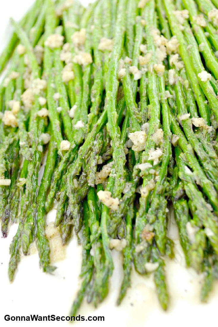 sauteed asparagus with garlic bits on top