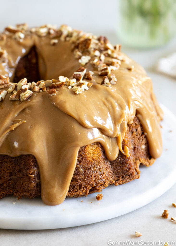 brown sugar caramel pound cake with caramel icing topped with chopped pecans