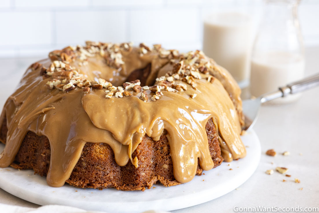 brown sugar pound cake with sour cream with caramel icing topped with chopped pecans