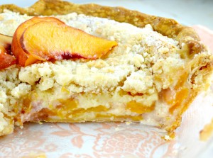 Sliced whole peaches and cream pie showing filling