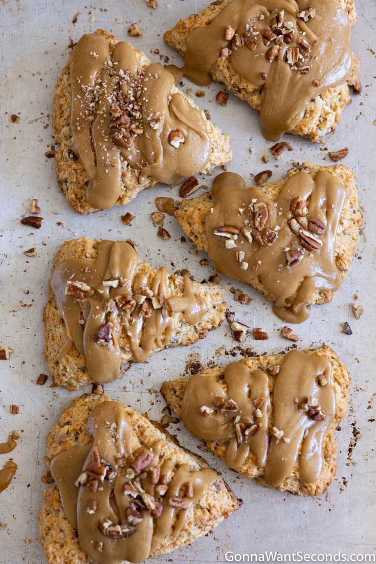 Slices of maple pecan scones on a baking sheet