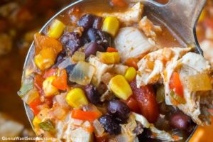 Ladle scooping Mexican chicken soup
