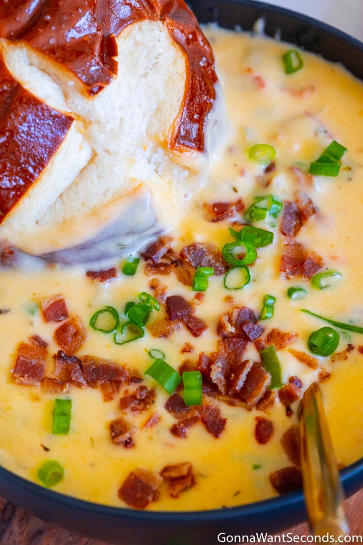 beer cheese soup with bacon and bread roll