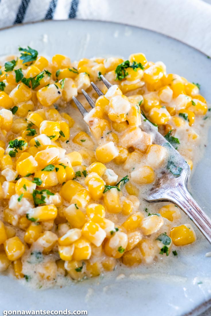 crockpot creamed corn with fork on a plate