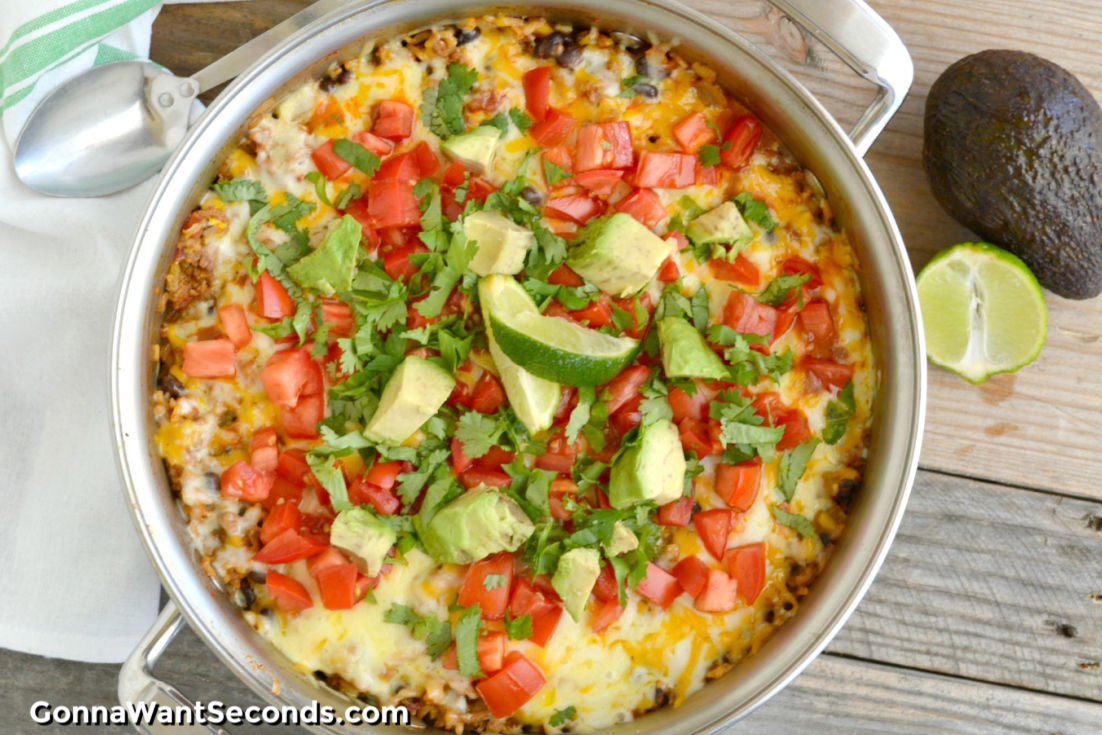 One Pot Burrito Bowl topped with chopped avocados and tomatoes in a pot