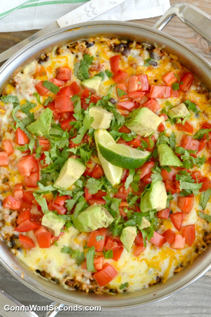 One Pot Burrito Bowl topped with chopped avocados and tomatoes in a pot
