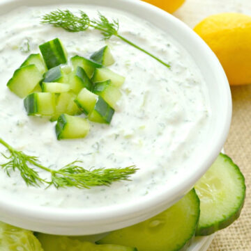 tzatziki sauce topped with chopped cucumber and dill