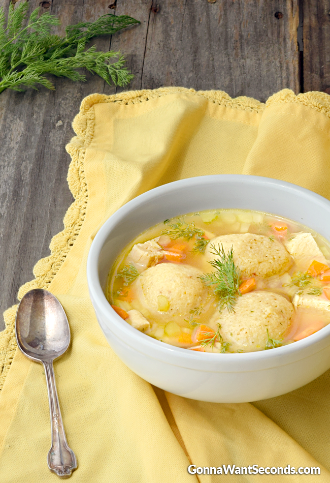Matzo Ball Soup, garnished with fresh dill in a white soup bowl