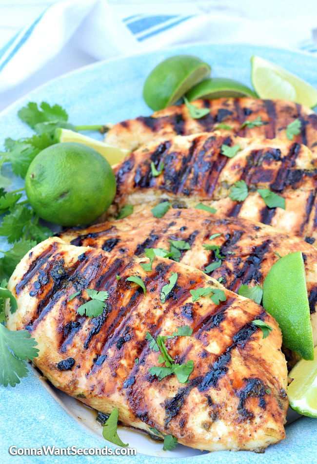 Cilantro Lime Chicken on a cilantro lime chicken marinade garnished with lime wedges and cilantro on a plate