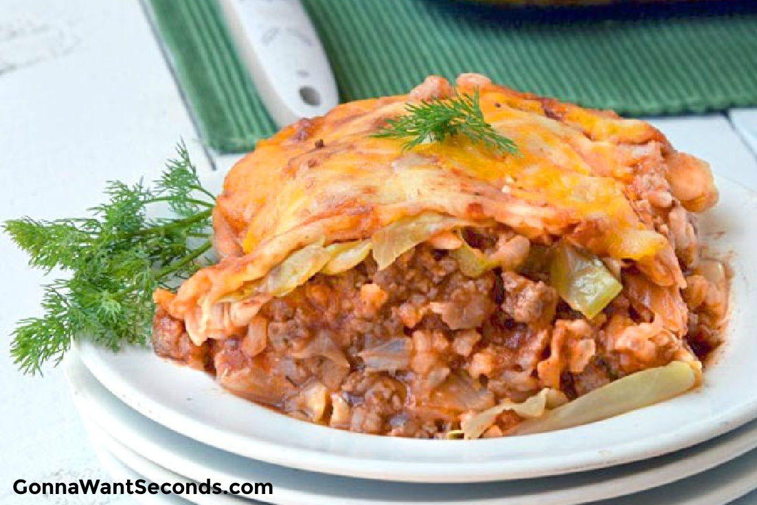 a slice of cabbage roll casserole with tomato soup on a plate