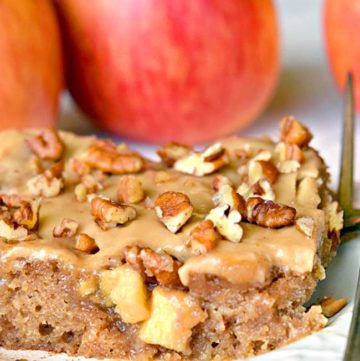 A slice of Caramel Apple Sheet Cake topped with caramel icing and chopped nuts