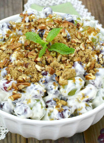 grape salad topped with crushed pecans in a bowl