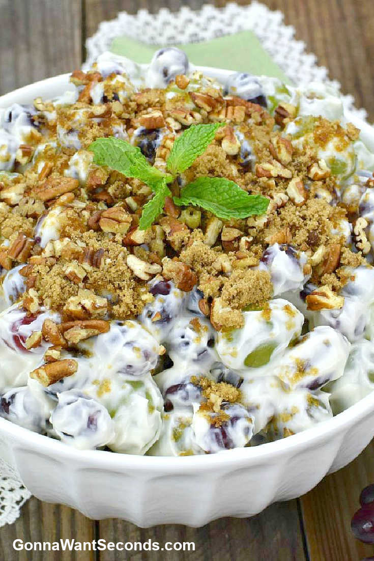 grape salad topped with crushed pecans in a bowl