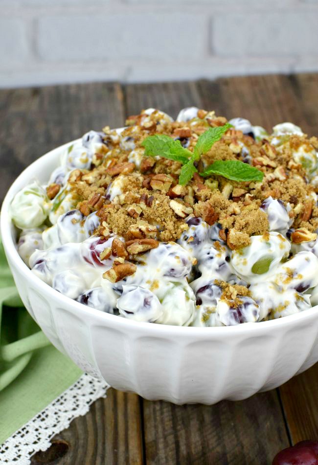 grape salad recipes topped with crushed pecans in a bowl