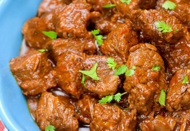 Carne Guisada- deliciously stewed chunks of beef in a chile, cumin, tomato gravy