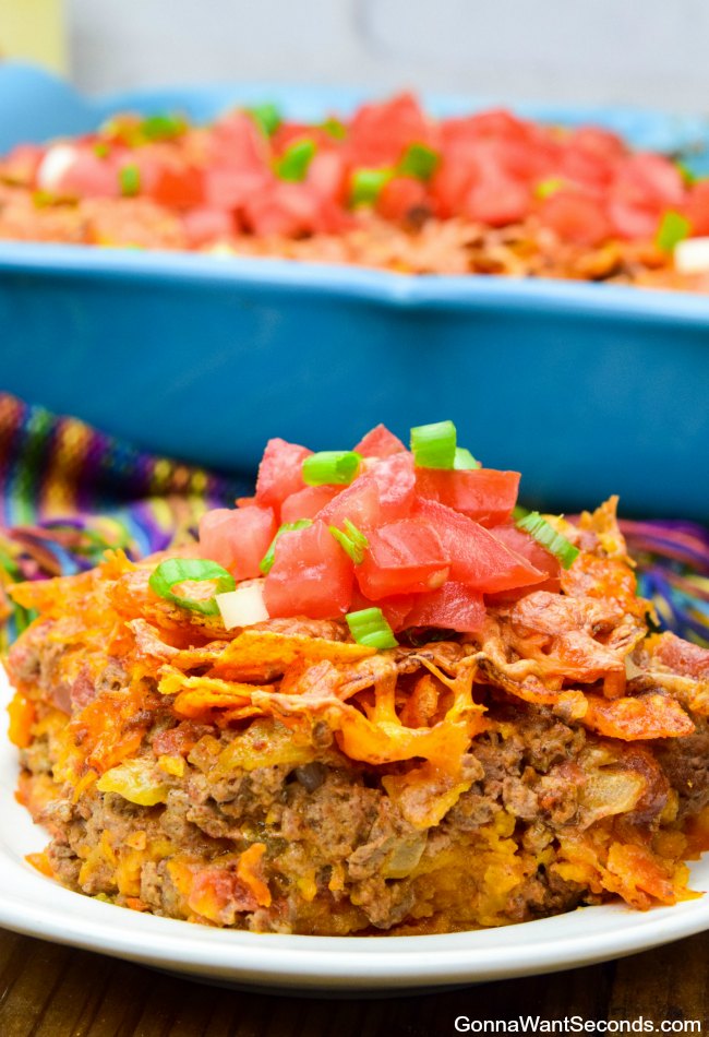 A single serving of Easy Dorito Casserole topped with fresh tomatoes on a plate