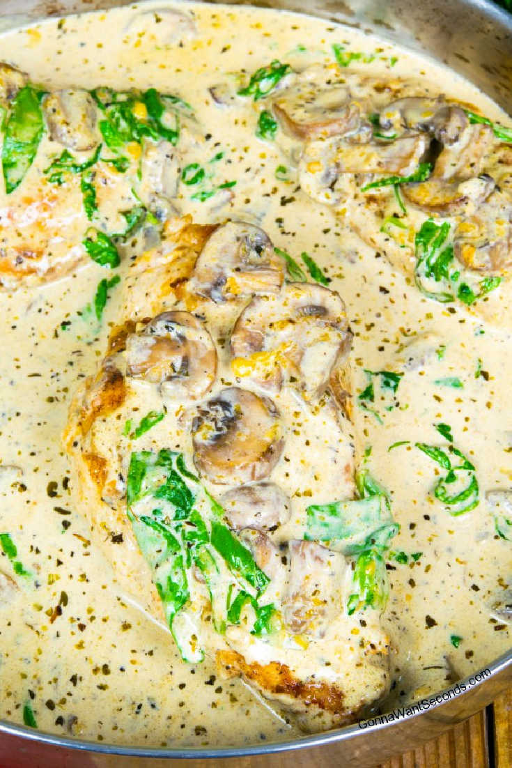 Chicken florentine smothered in sauce on a pan