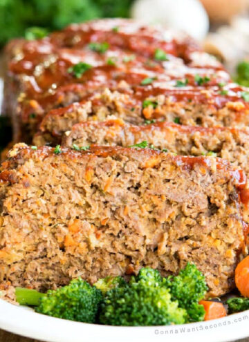 Sliced alton brown meatloaf with veggies around it