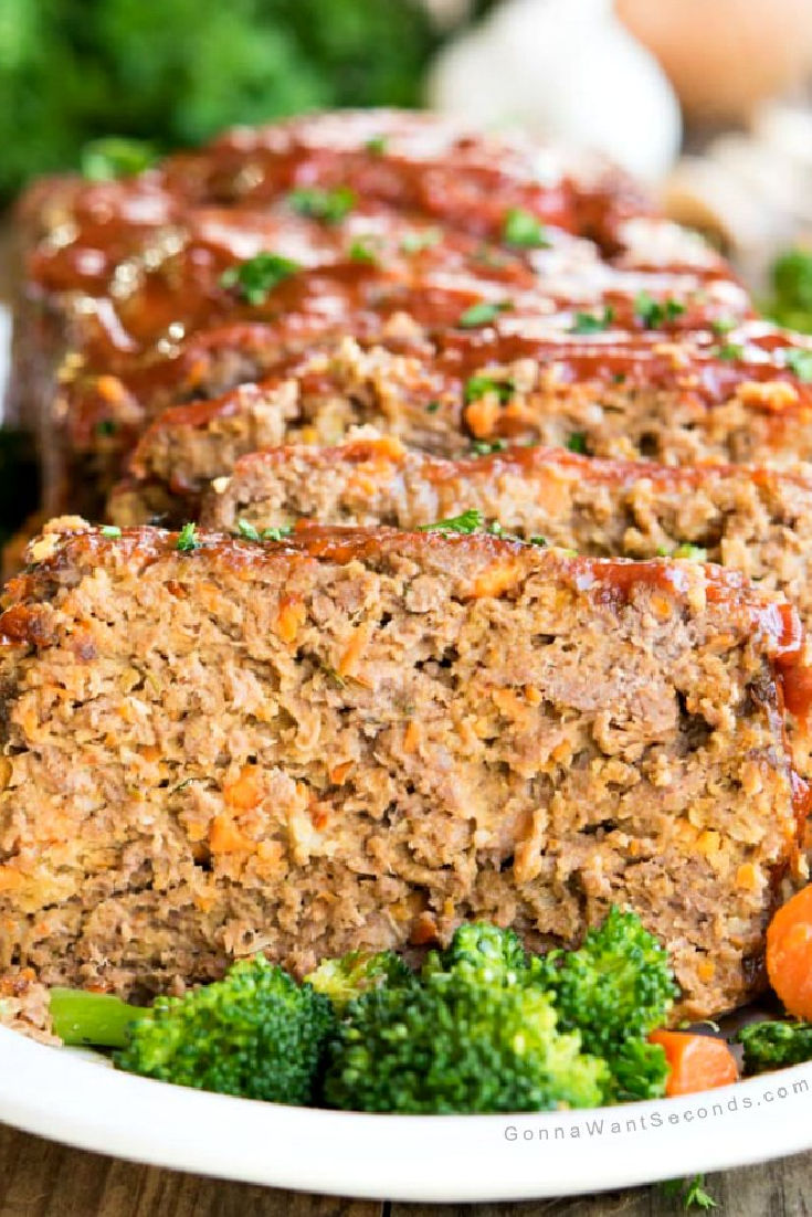 Sliced alton brown meatloaf with veggies around it