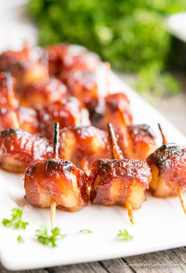 Bacon Wrapped Water Chestnuts on a White Rectangular Platter