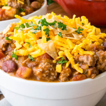 Taco Chili topped with shredded cheese in a white bowl