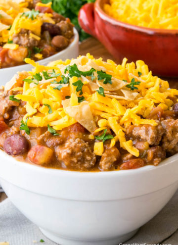 Taco Chili topped with shredded cheese in a white bowl
