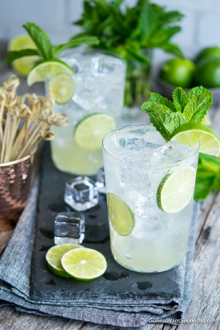 glasses of lime rickey with ice, garnished with lime wedgest and mint leaves