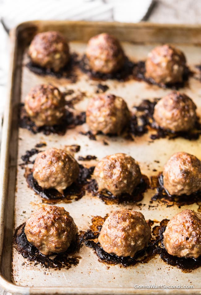 Cooked Baked Meatballs arranged on a baking sheet