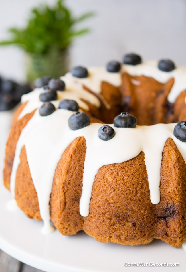 Whole sour cream blueberry coffee cake topped with fresh blueberries