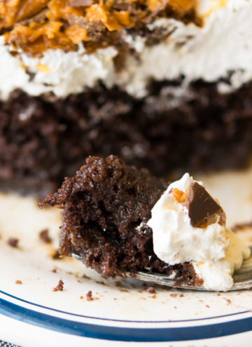 A slice Butterfinger Cake and a piece of cake on fork